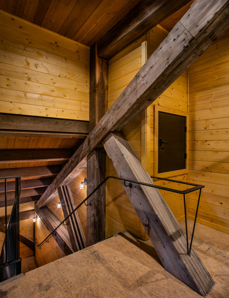 Modelo de escalera en U rural de tamaño medio con escalones de madera, contrahuellas de madera y barandilla de metal
