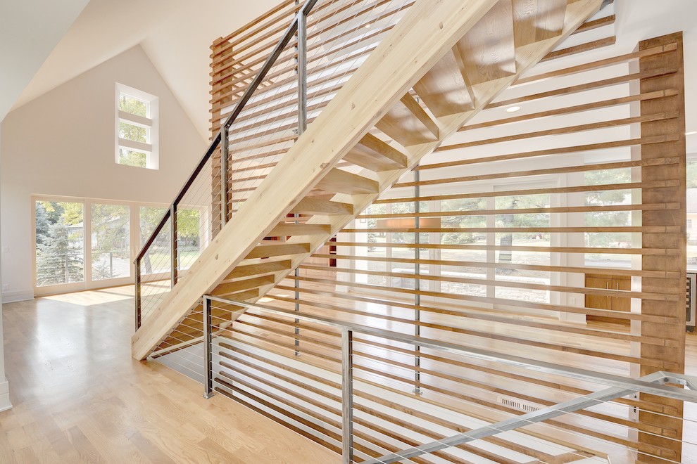 Inspiration for a contemporary wood straight staircase in Minneapolis with open risers.
