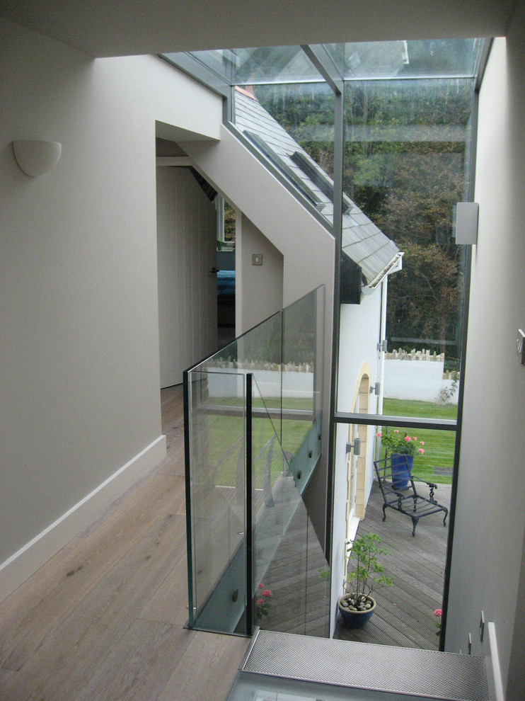 Modern glass railing staircase in Devon.