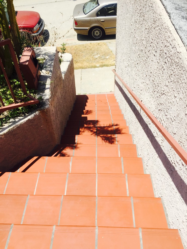 Photo of a medium sized mediterranean concrete straight staircase in Los Angeles with tiled risers.