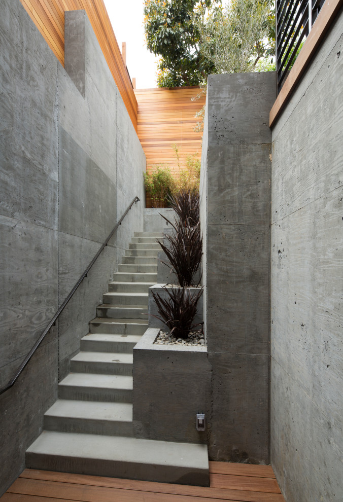 Inspiration for a mid-sized modern concrete straight metal railing staircase remodel in San Francisco with concrete risers