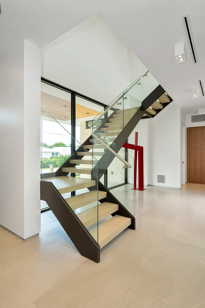 This is an example of a world-inspired staircase in Miami with feature lighting.