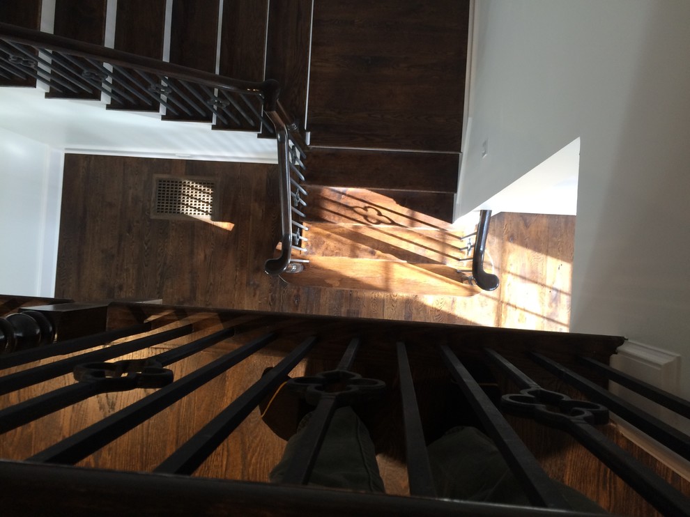 Inspiration for a mid-sized transitional wooden u-shaped staircase remodel in Charlotte with wooden risers