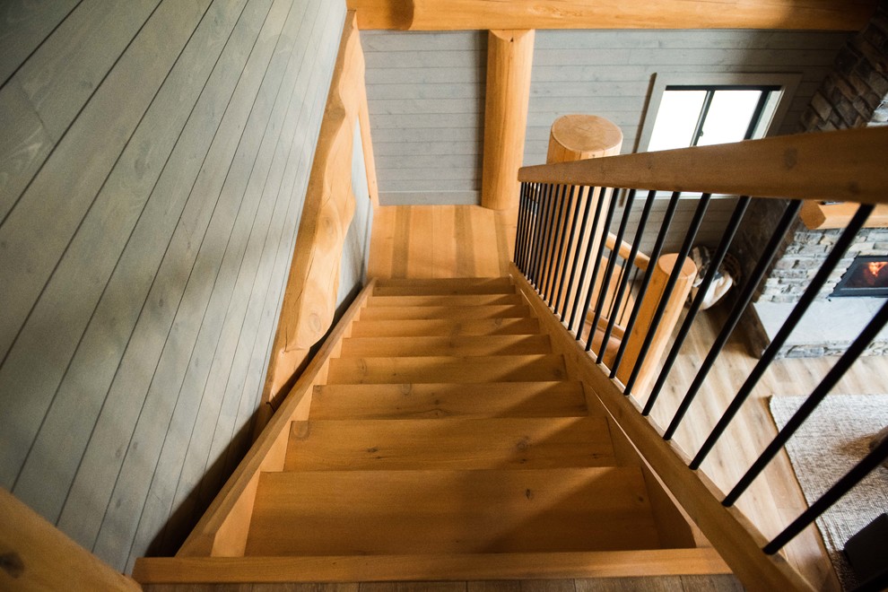 Modelo de escalera en L rústica de tamaño medio sin contrahuella con escalones de madera y barandilla de madera