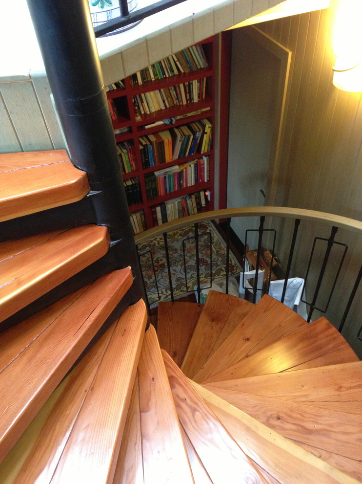 Classic wood spiral staircase in San Francisco with metal risers.