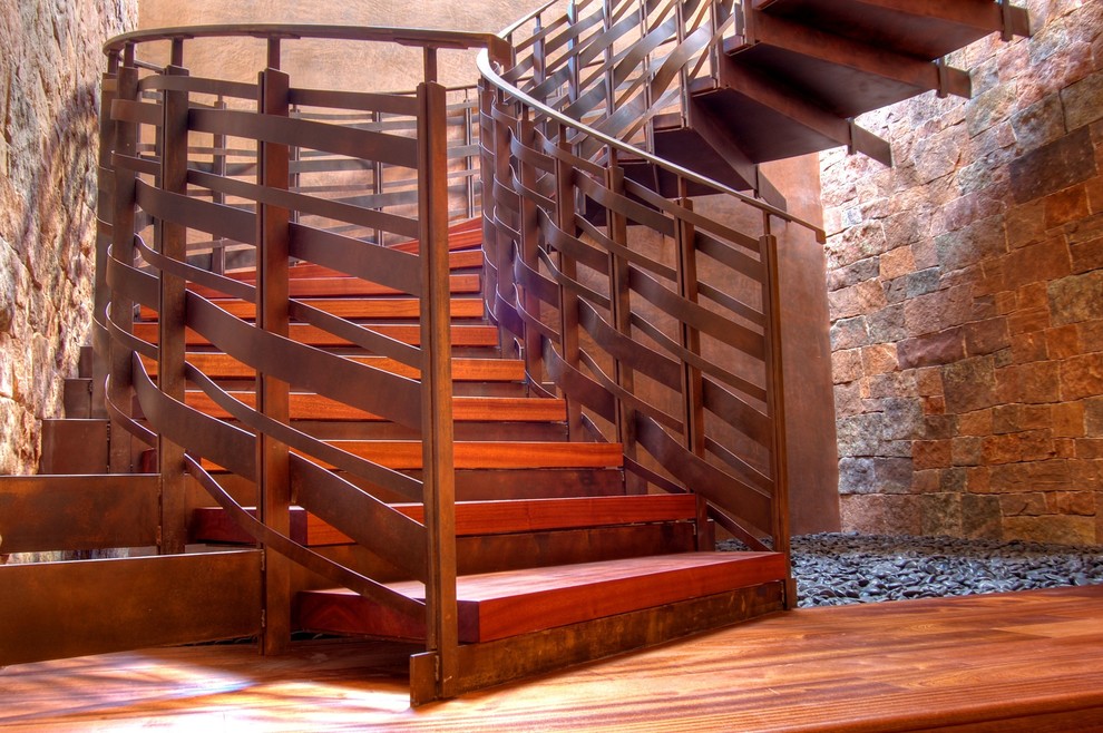 This is an example of a traditional curved staircase in Albuquerque with metal risers.