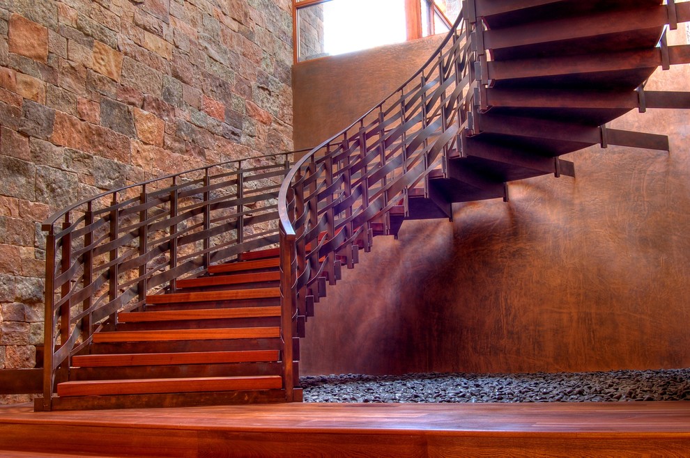 Classic curved staircase in Albuquerque with metal risers.