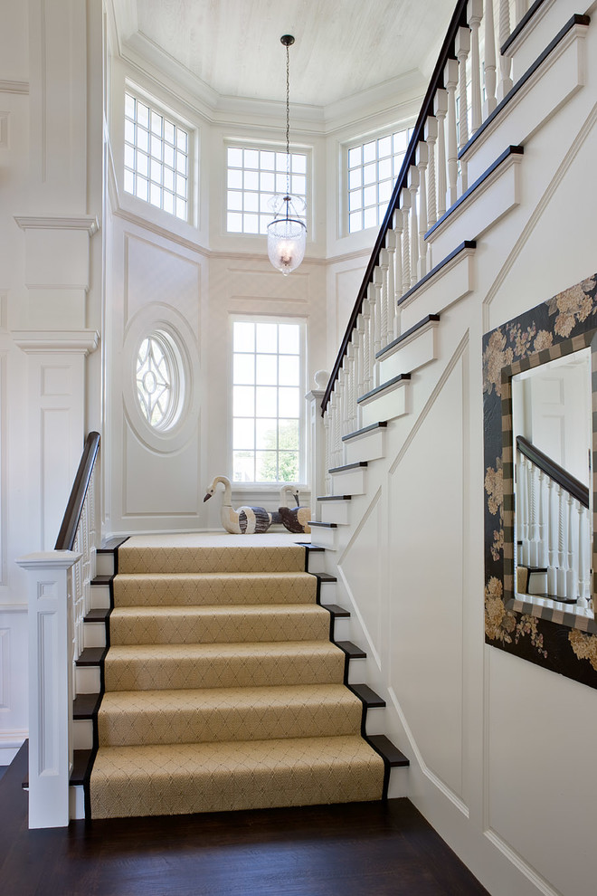 Inspiration for a coastal wood u-shaped staircase in Boston with painted wood risers.