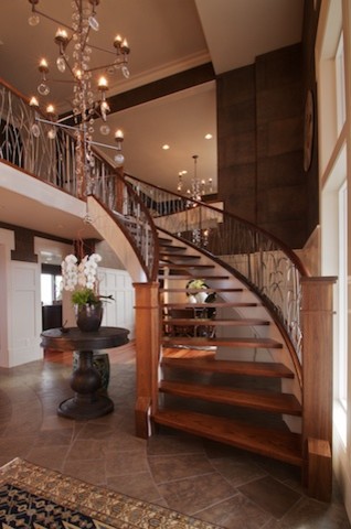 Large traditional wood curved staircase in Seattle.