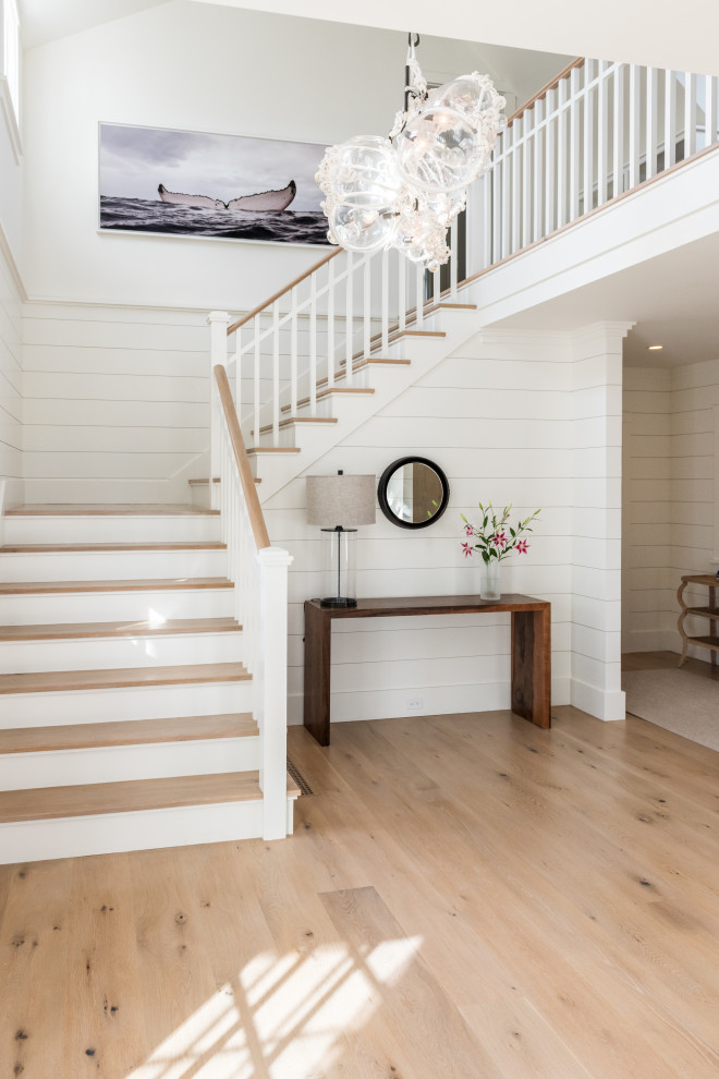 Inspiration for a beach style wood u-shaped wood railing staircase in Boston with painted wood risers and tongue and groove walls.