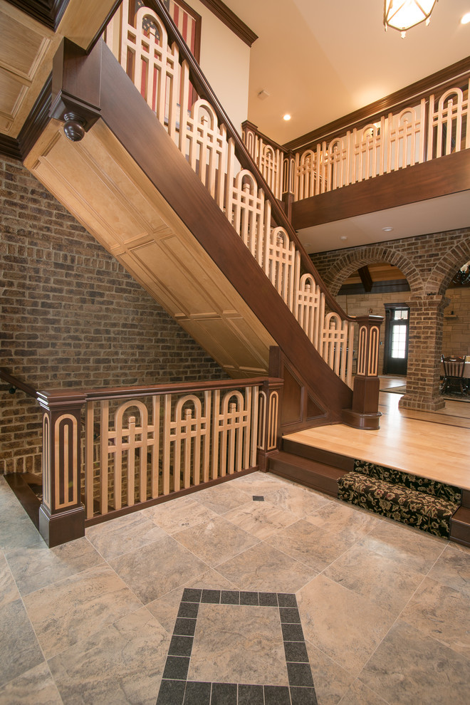 This is an example of a large traditional wood straight staircase in Cleveland with wood risers.