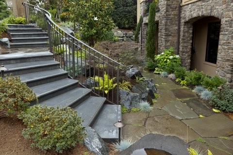 Inspiration for a large contemporary concrete curved staircase remodel in Seattle with metal risers
