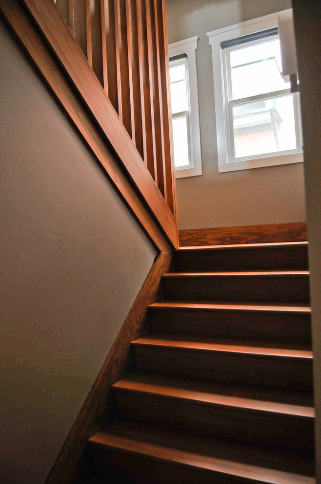 Mid-sized arts and crafts wooden l-shaped staircase photo in Seattle with wooden risers