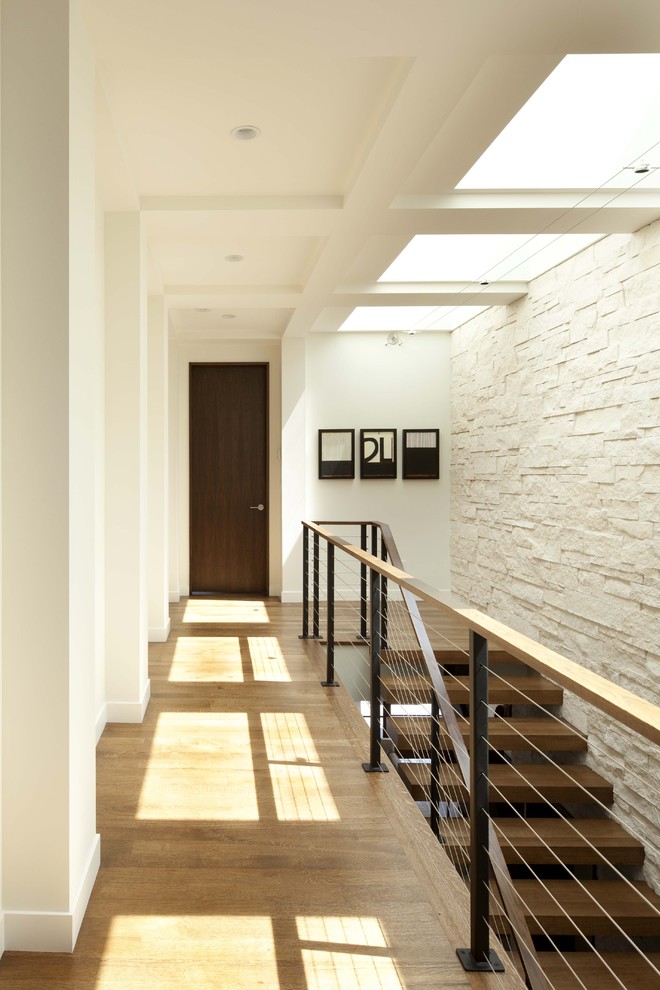 This is an example of a contemporary wood staircase in Minneapolis with open risers.