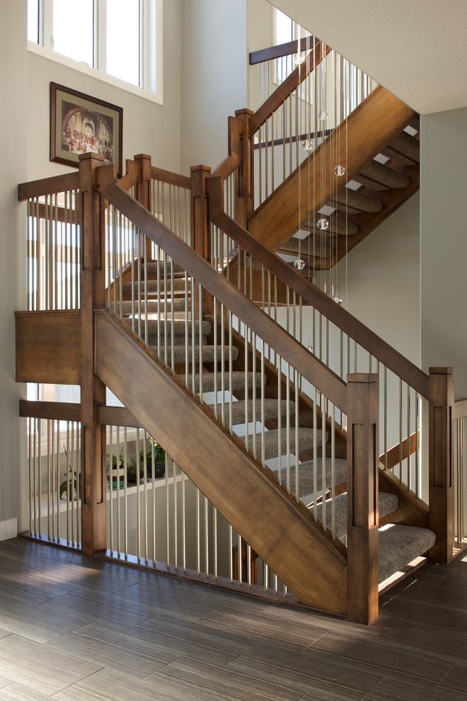 Contemporary carpeted l-shaped wood railing staircase in Edmonton with open risers.