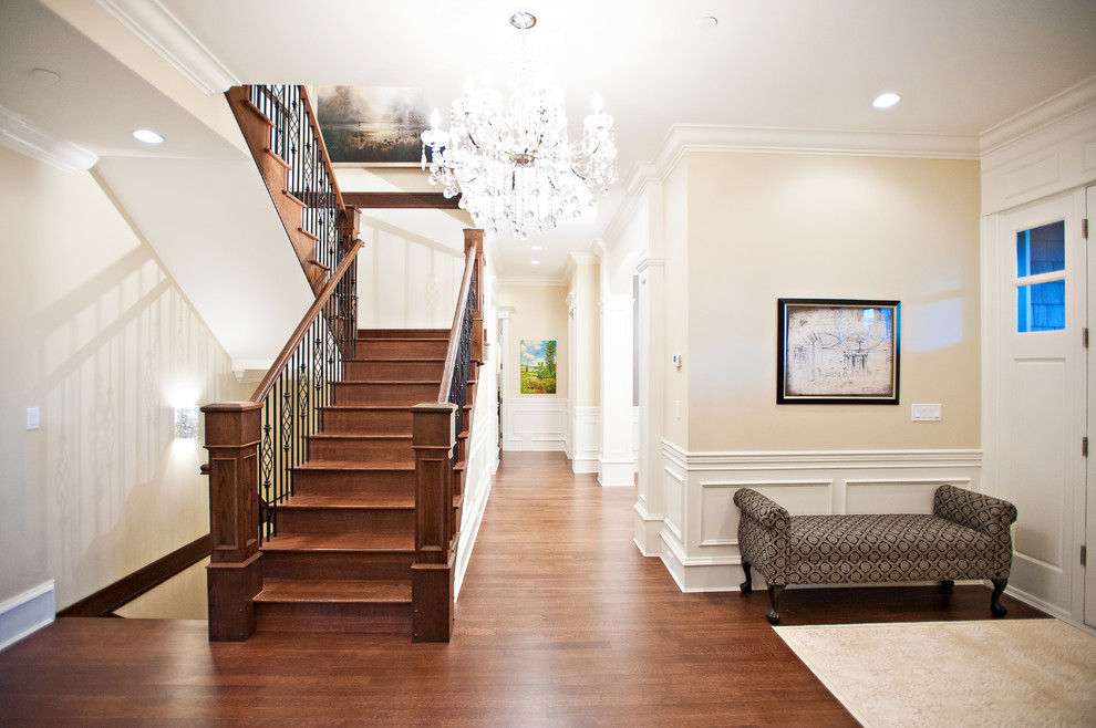 Design ideas for a medium sized traditional wood u-shaped metal railing staircase in Vancouver with wood risers.