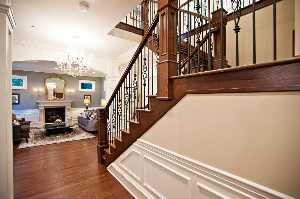 Staircase - mid-sized traditional wooden u-shaped metal railing staircase idea in Vancouver with wooden risers