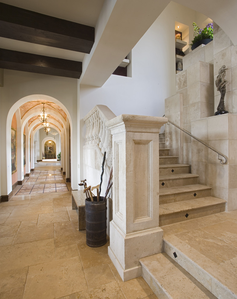 Inspiration for a mediterranean metal railing staircase in Austin with travertine treads and travertine risers.