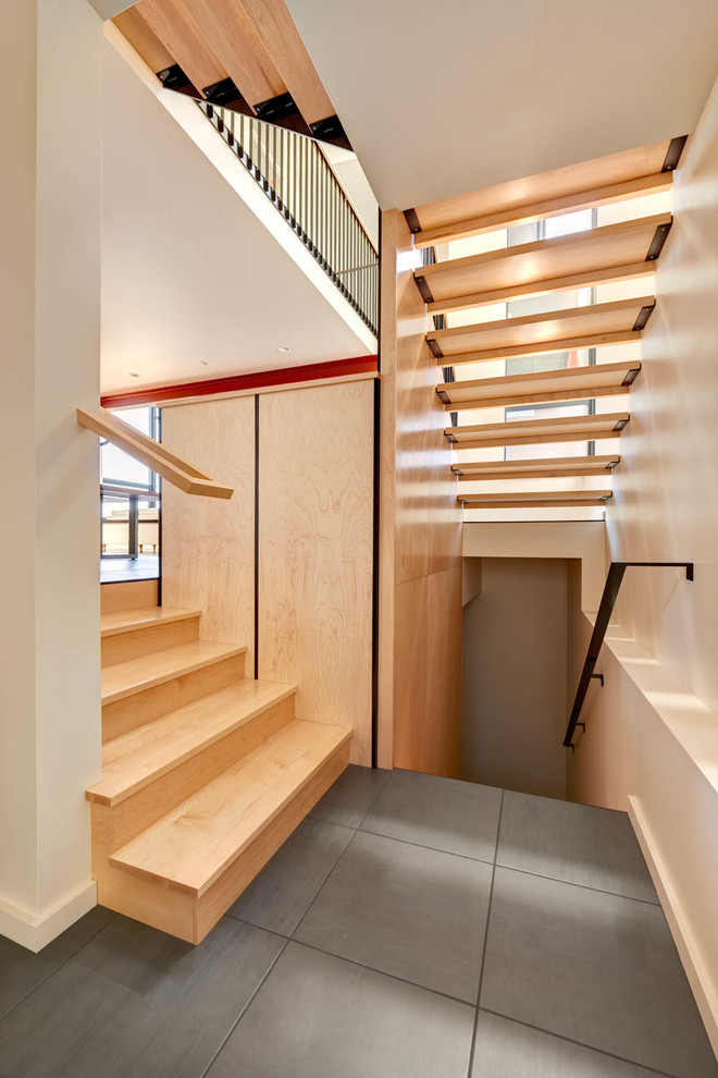 Large minimalist wooden u-shaped open staircase photo in Seattle