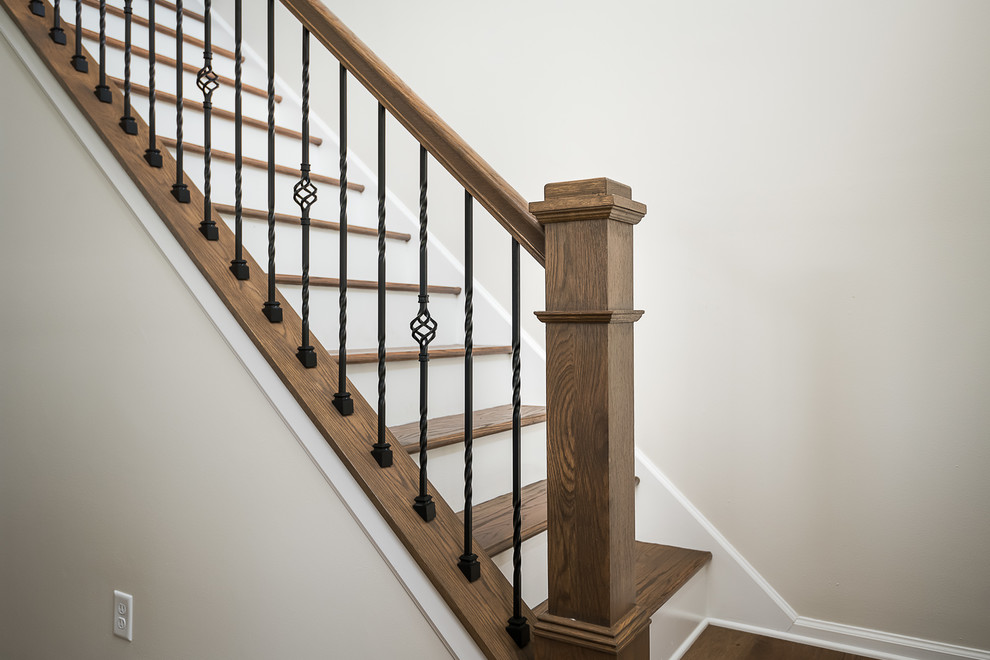 This is an example of a large country wood straight mixed railing staircase in Other with painted wood risers.