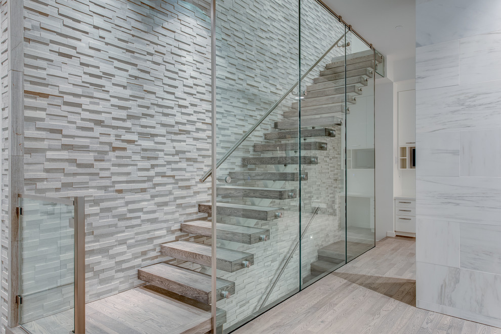 Medium sized contemporary wood straight staircase in Vancouver with open risers.