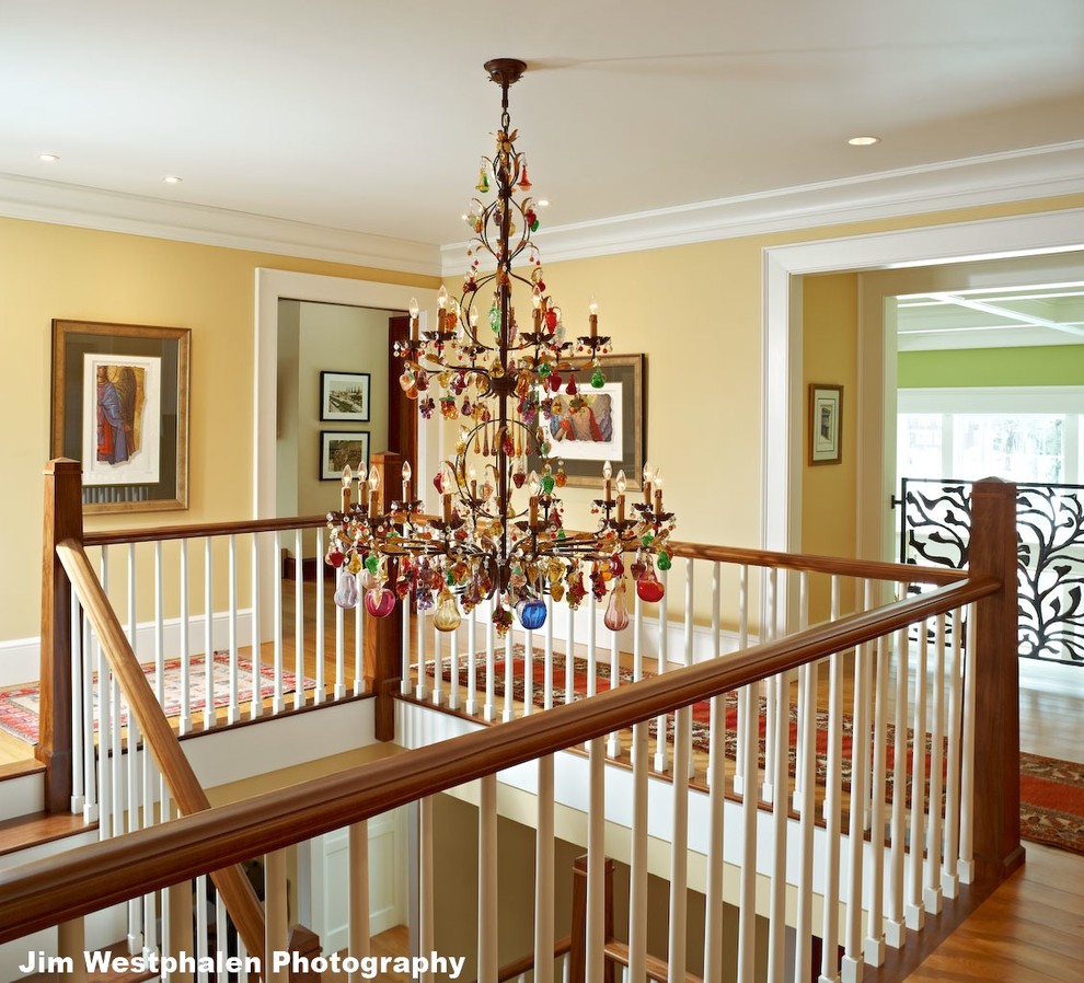 Photo of a large classic wood l-shaped staircase in Burlington with painted wood risers.