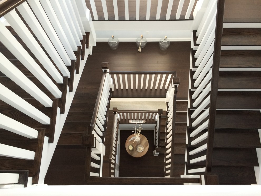Example of a mid-sized beach style wooden u-shaped staircase design in New York with wooden risers