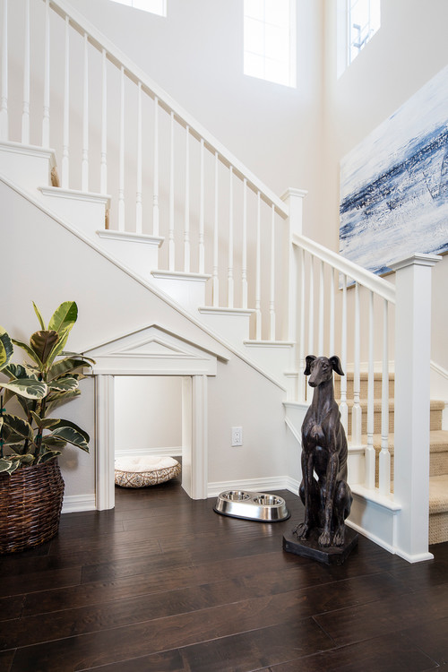 white stairway with beige carpet with fancy dog room underneath the stairs