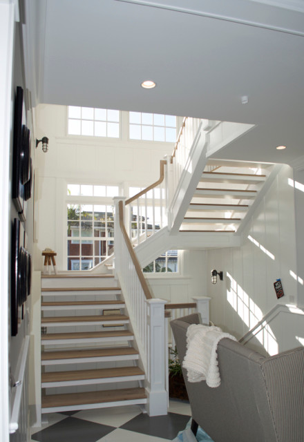 Example of a huge beach style wooden floating open staircase design in San Diego