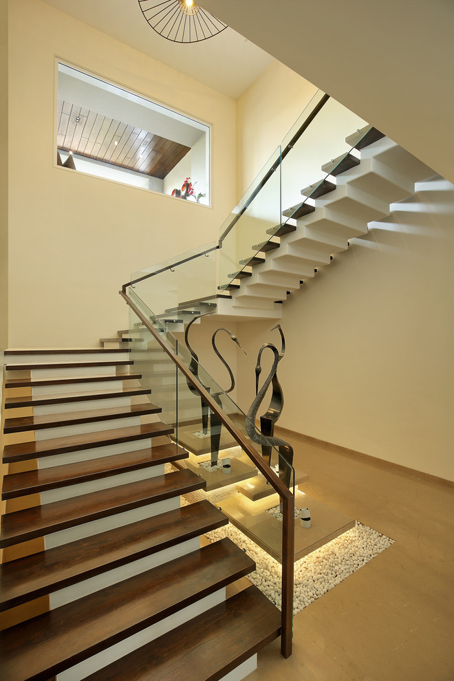 Contemporary staircase in Ahmedabad with feature lighting.