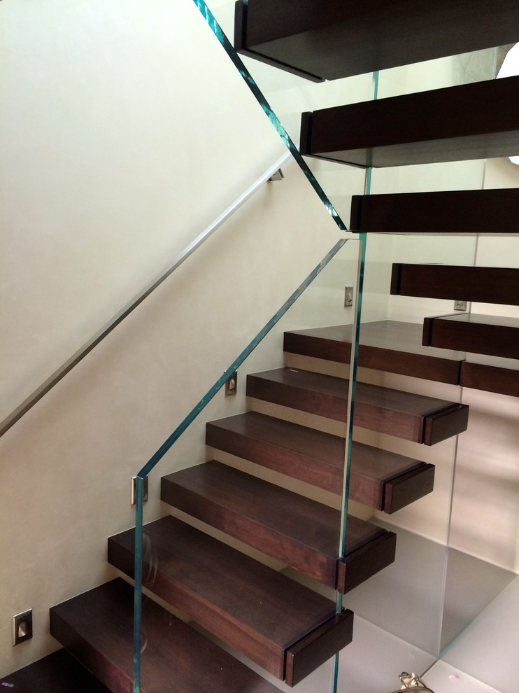 Inspiration for a small contemporary wood floating staircase in San Diego with open risers.