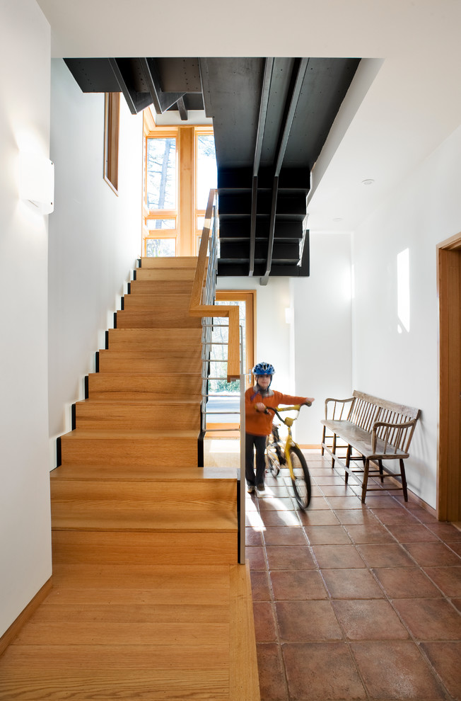 This is an example of a contemporary wood straight staircase in Boston with wood risers.