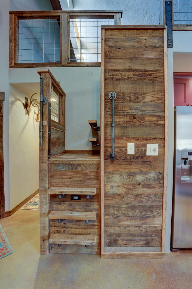 Small rustic wood l-shaped metal railing staircase in Other with metal risers.