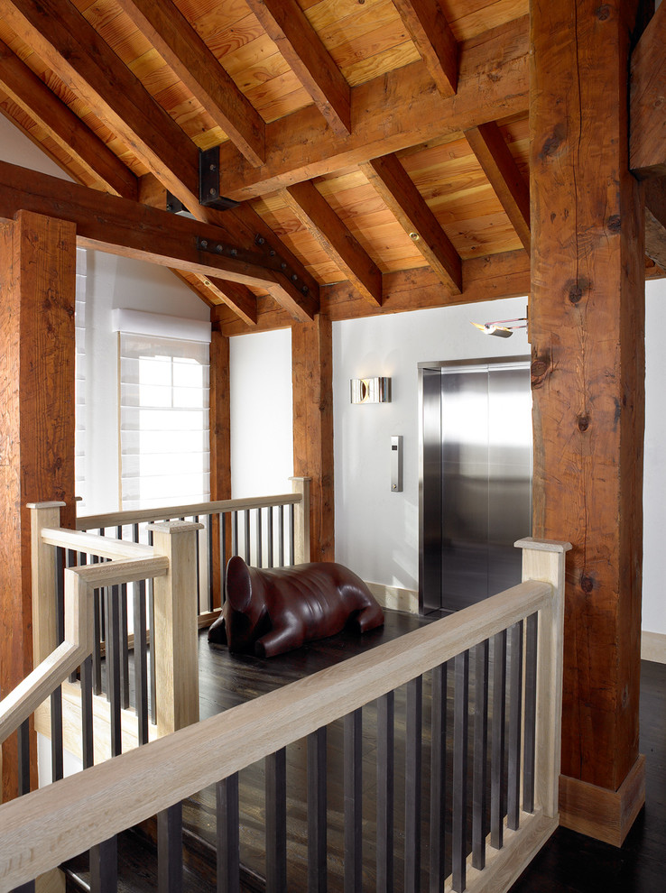 Inspiration for a mid-sized rustic wooden u-shaped wood railing staircase remodel in Other with wooden risers