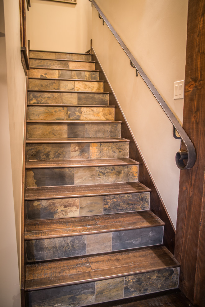 Example of a mountain style wooden staircase design in Denver with slate risers
