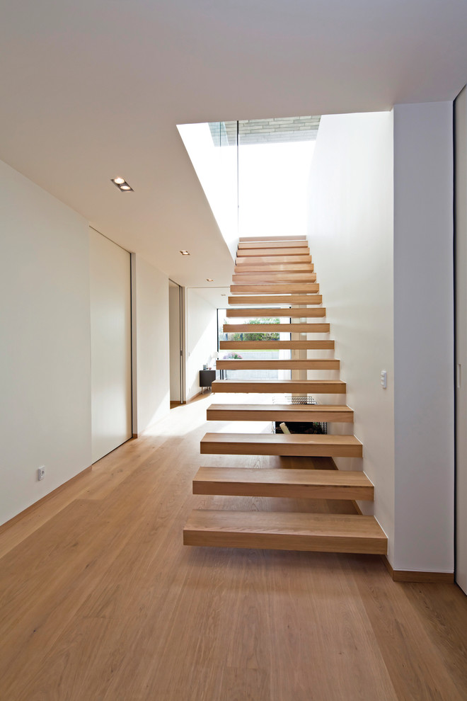 Inspiration for a modern wood floating staircase in London with open risers.