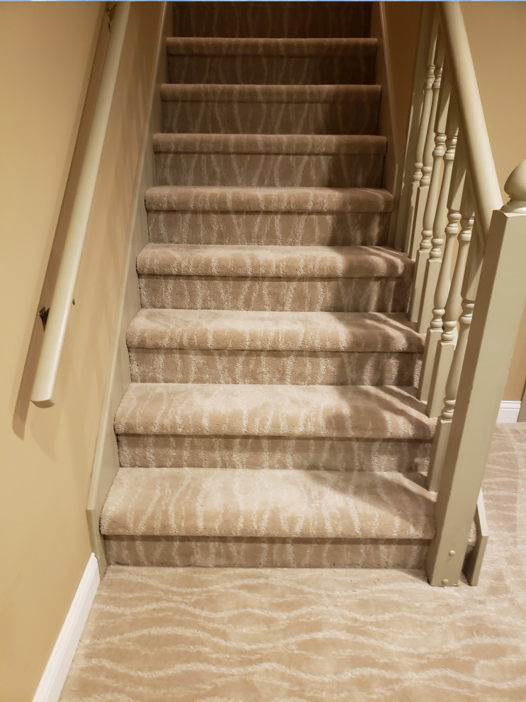 Medium sized traditional carpeted straight wood railing staircase in Indianapolis with carpeted risers.