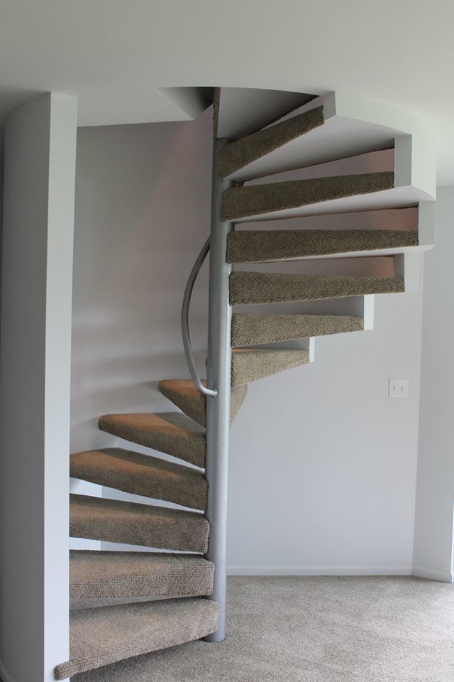 Inspiration for a mid-sized carpeted spiral staircase remodel in Seattle with carpeted risers