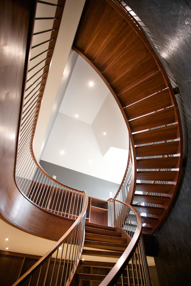 Trendy wooden curved open staircase photo in Edmonton