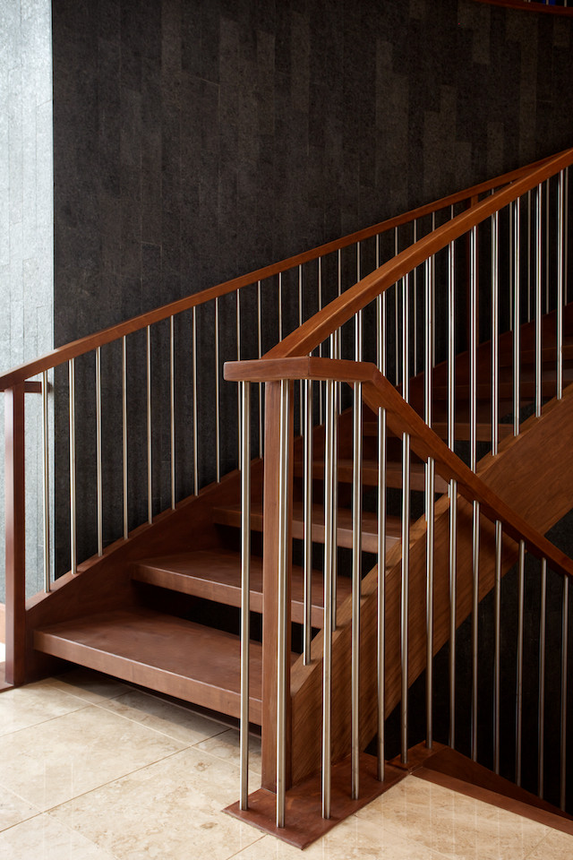 Photo of a contemporary wood curved staircase in Edmonton with open risers.