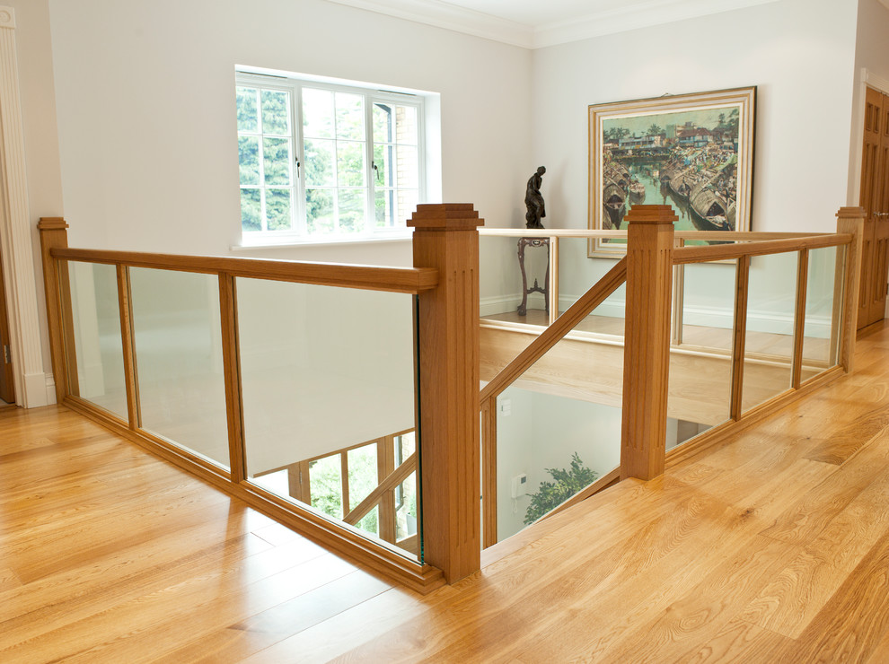 This is an example of a medium sized contemporary wood l-shaped mixed railing staircase in Hampshire with wood risers.