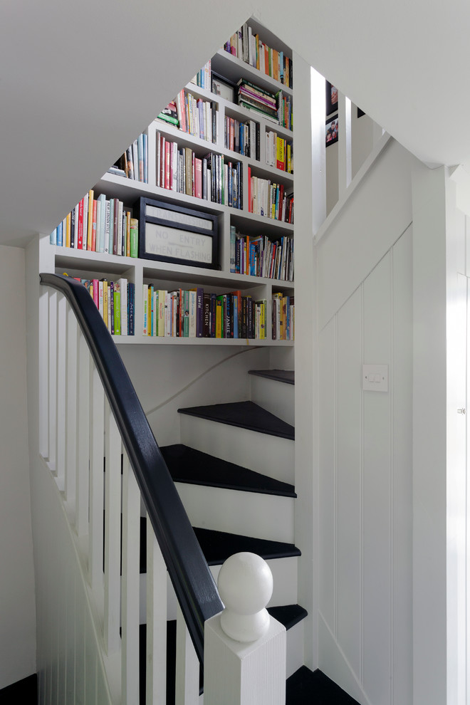 Inspiration for a small farmhouse wooden curved staircase remodel in Cornwall with painted risers