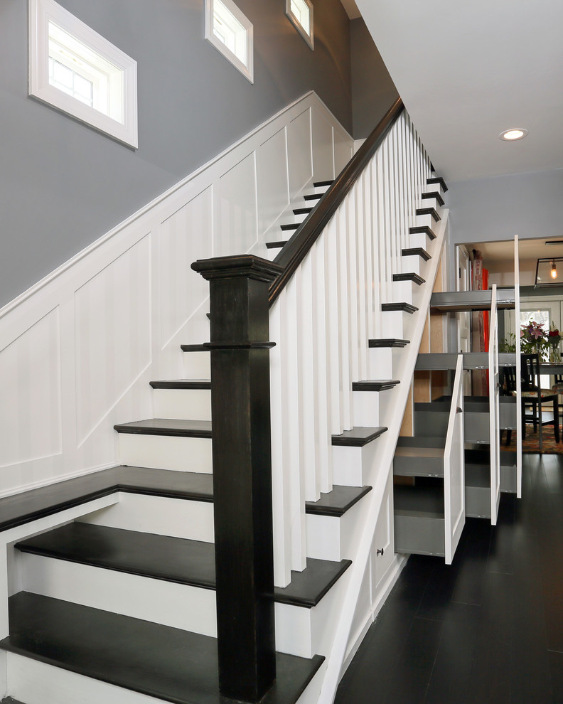 Medium sized modern painted wood straight staircase in Boston with painted wood risers and under stair storage.