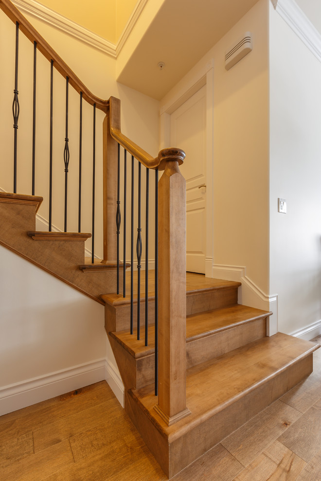 Inspiration for a mid-sized timeless wooden l-shaped staircase remodel in Vancouver with wooden risers