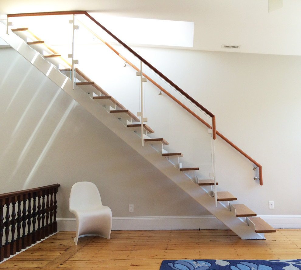 Example of a mid-sized transitional wooden straight staircase design in Boston with painted risers