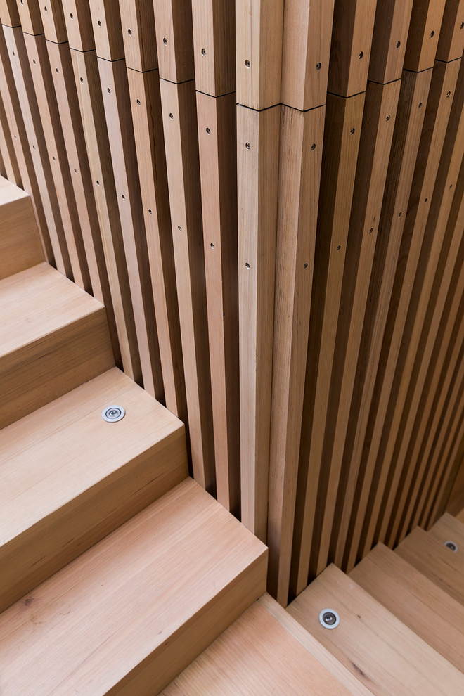Foto de escalera en U contemporánea de tamaño medio con escalones de madera y contrahuellas de madera