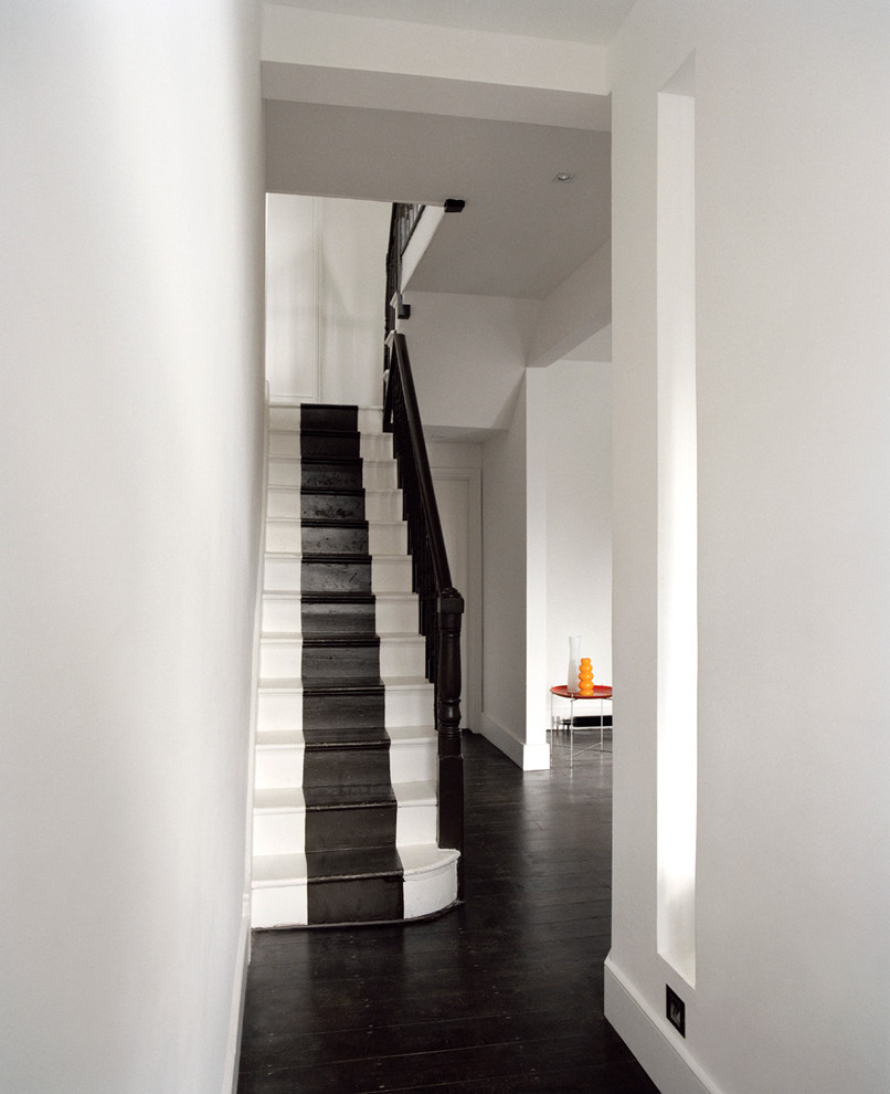 Inspiration for a contemporary painted wood straight staircase in London with painted wood risers.