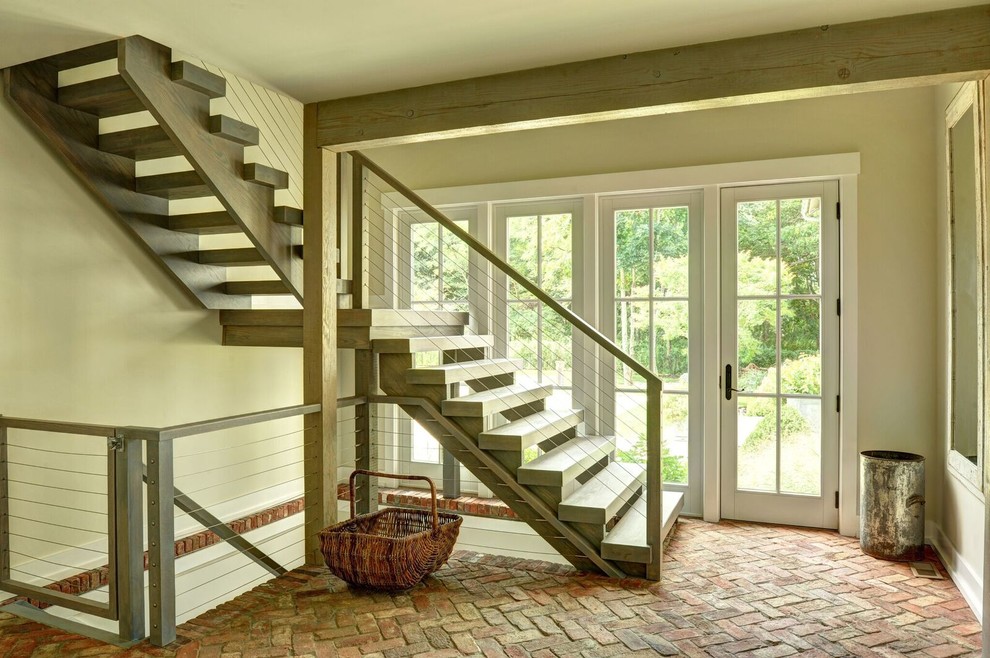 Imagen de escalera en L de estilo de casa de campo grande sin contrahuella con escalones de madera
