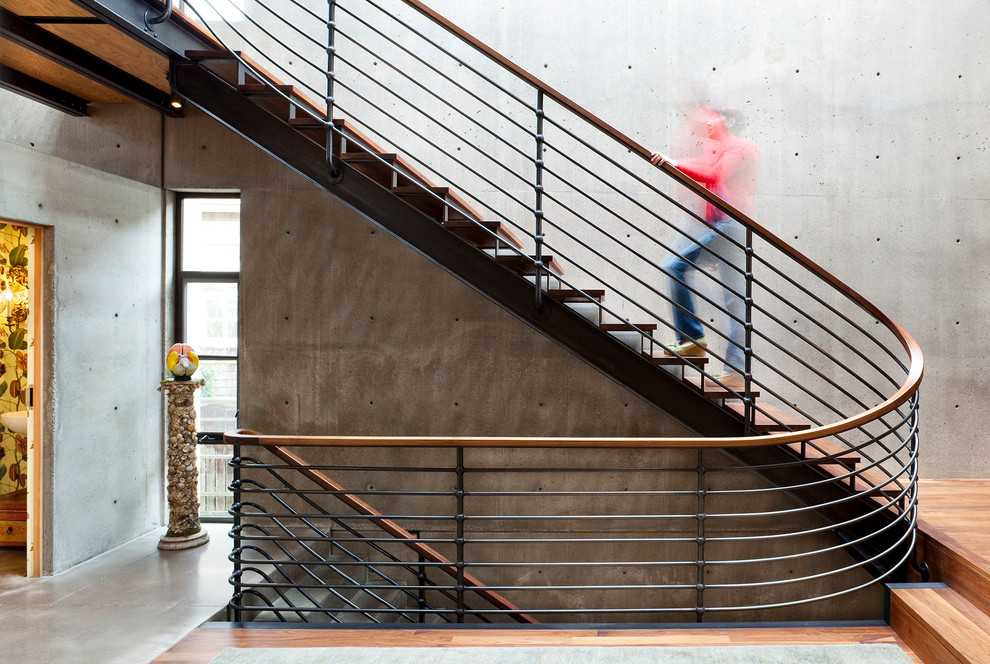 Photo of a contemporary wood metal railing staircase in Seattle with open risers.