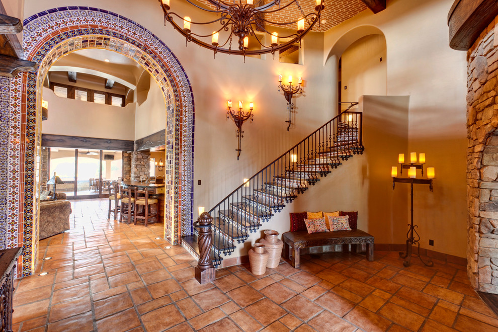 Example of a tuscan wooden metal railing staircase design in Other with tile risers
